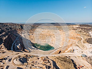 Opencast limestone mining quarry, aerial view. Industrial production and transportation of minerals, ore and gravel