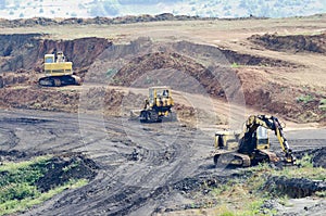 Opencast mining quarry with lots of machinery at work