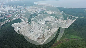 Opencast mining quarry with machinery. Quarrying of stones for construction works. Mining industry in quarry.