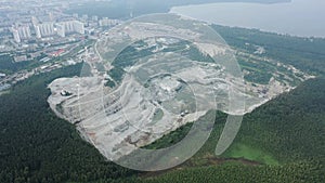 Opencast mining quarry with machinery. Quarrying of stones for construction works. Mining industry in quarry.