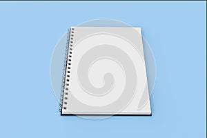 Opend notebook spiral bound on blue background