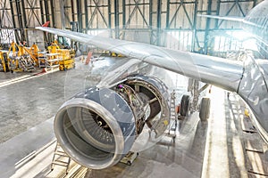 Opened aircraft engine in the hangar, maintenance. Wing view