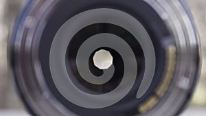 Opened aperture of a professional camera lens, close up. Opened camera lens diaphragm, front view, photography concept.
