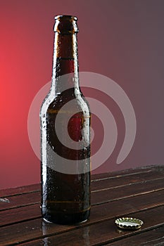 Opened beer bottle on a wooden table