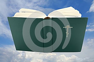 Opened bible book over sky with clipping path