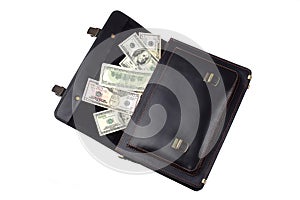 Opened black leather briefcase with dollars isolated on white ba