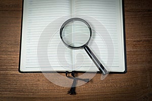 Opened blank notebook with Magnifying Glass