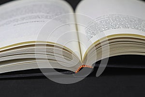 Opened book on black background