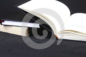 Opened book on black background