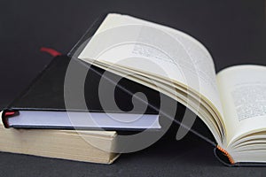 Opened book on black background