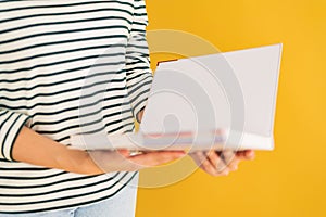 Opened book in hands isolated on white background
