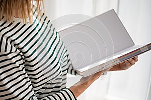 Opened book in hands isolated on white background