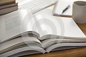 Opened book pile put on table