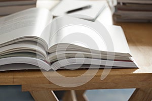Opened book pile put on table