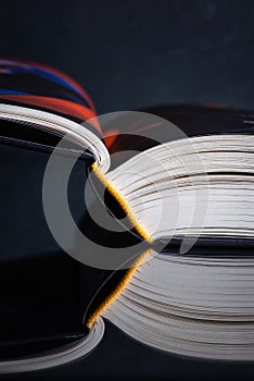 Opened book with reflection on table