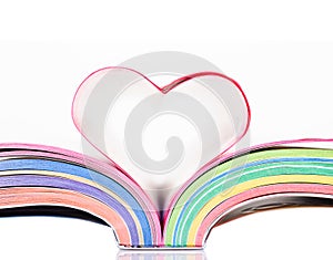 Opened book with sheets in the form of heart.