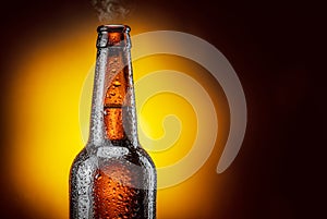 Opened bottle of cold beer and gas output isolated on a yellow background