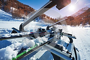 Opened car roof rails with two pairs of skis