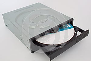 Opened CD - DVD drive with a black cap and disk inside.