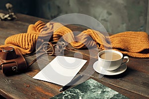 Opened craft paper envelope , autumn leaves and coffee on wooden table