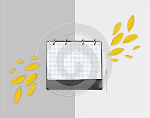 Opened day planner with yellow petals and pencil on light background. Flat lay. Workspace with checkered sheet, place for text
