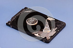 Opened disassembled hard drive from the computer, hdd with mirror effect. on blue background