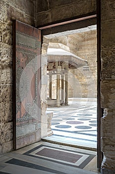 Opened door leading to the courtyard of Al-Sultan Al-Zahir Barquq mosque, Cairo, Egypt