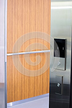 Opened elevator doors. Elevator call button