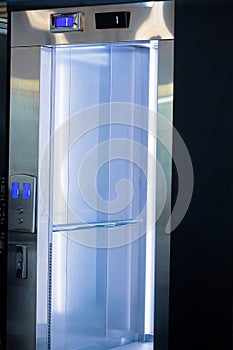 Opened elevator doors. Modern elevator with a mirror inside