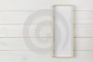 Opened empty cardboard box with cover on white wooden background. top view with copy space