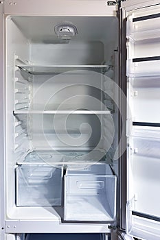 Opened empty refrigerator. Empty fridge inside interior