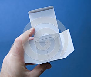 Opened Empty White Cardboard Box in Hand