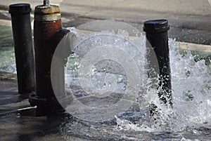 Opened firehydrant in the city streets