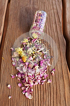 Opened glass bottle with dry mix of flowers