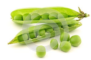 Opened green pea pods with peas visible