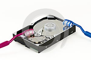 Opened hard-disc with two toothbrushes