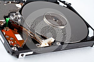 Opened hard disk drive, with water drops