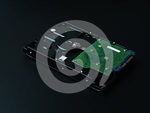 Opened hard drive disk on dark background.