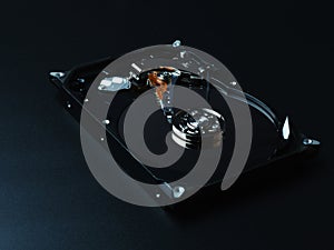 Opened hard drive disk on dark background.