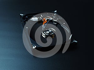 Opened hard drive disk on dark background.