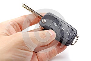 Opened ignition key with immobilizer in man`s hands