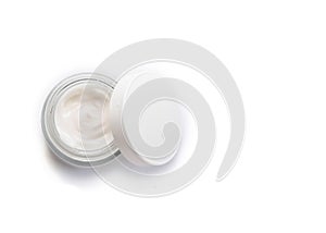 Opened jar of facial cream isolated on the white background