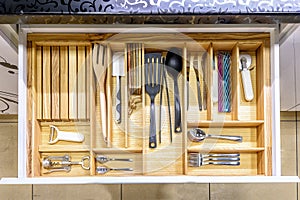 Opened kitchen drawer , a smart solution for kitchen storage and organizing photo