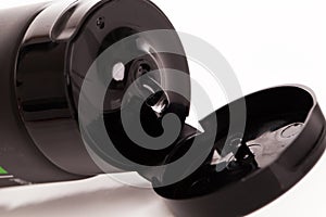 Opened lotion tube on a white table