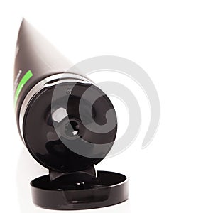 Opened lotion tube on a white table