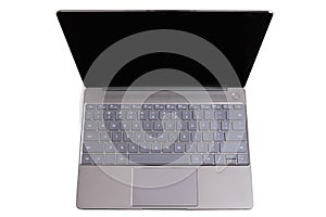 Opened modern laptop with US keypad, touchpad and empty blank screen isolated on white background top view closeup