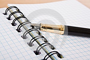 Opened notebook with pen