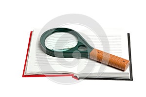 Opened notepad with magnifying glass isolated on white background