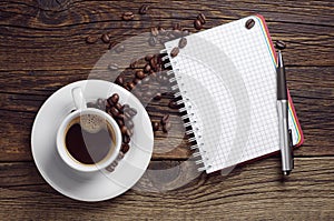 Opened notepad pen and coffee