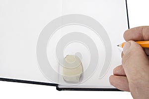 Opened notepad with pen or pencil on the white background.